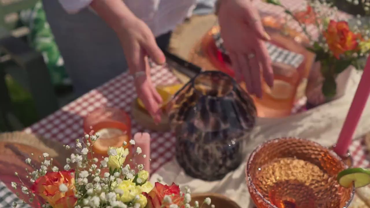 Load video: The refillable candle lamp is being lit outdoors at an aesthetic garden setting with friends